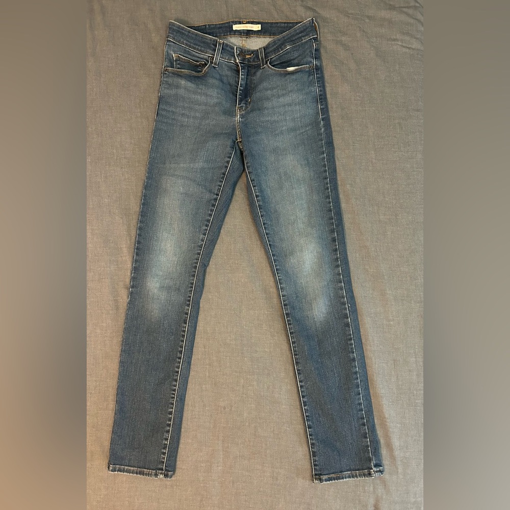 Mid rise skinny jeans in a blue wash, size 4, probably a 30-31” length.